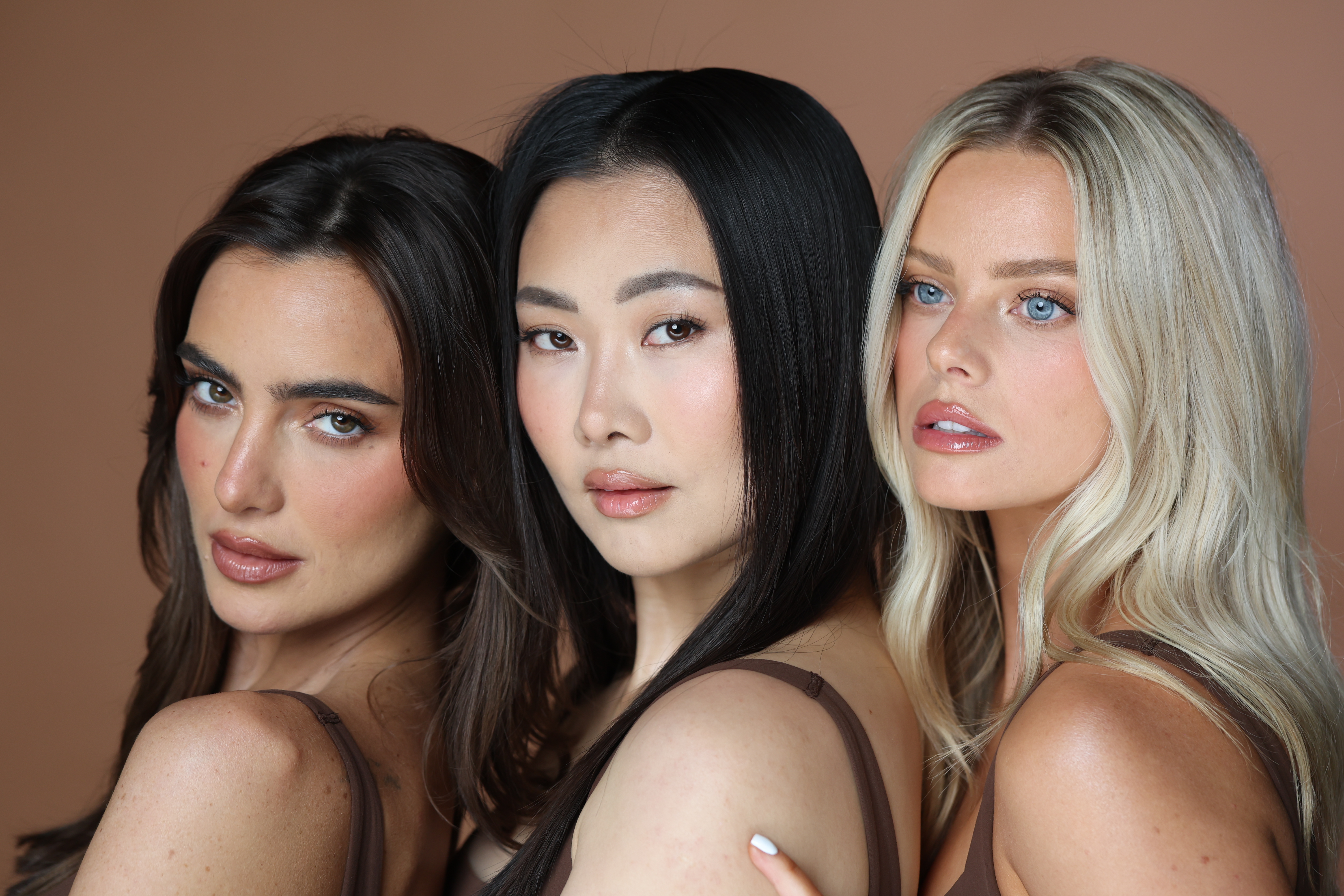 Woman touching her jaw and neck area, showing smooth tightened skin